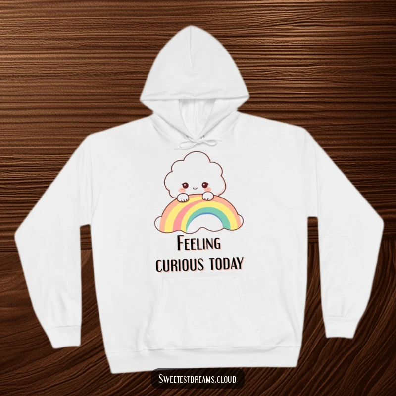 Funny hoodie featuring a curious cloud character peeking over a colorful rainbow, exuding playful wonder and warmth.