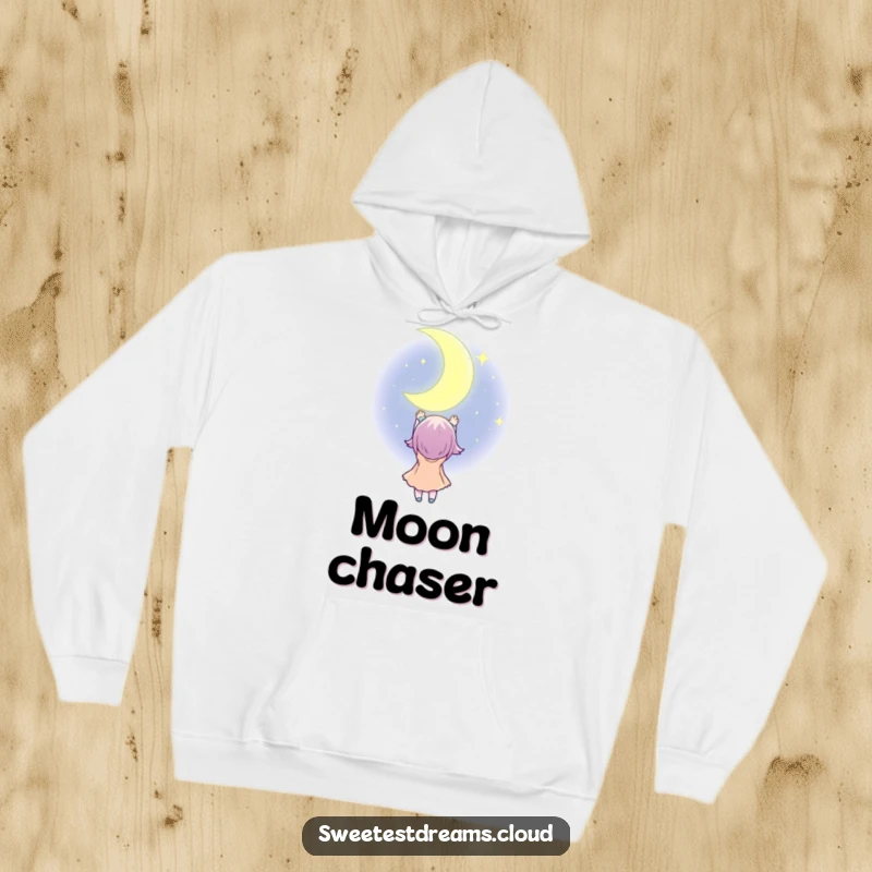 Funny Hoodie illustrating a character reaching for a sparkling, oversized crescent moon, symbolizing dreams and cozy ambition.